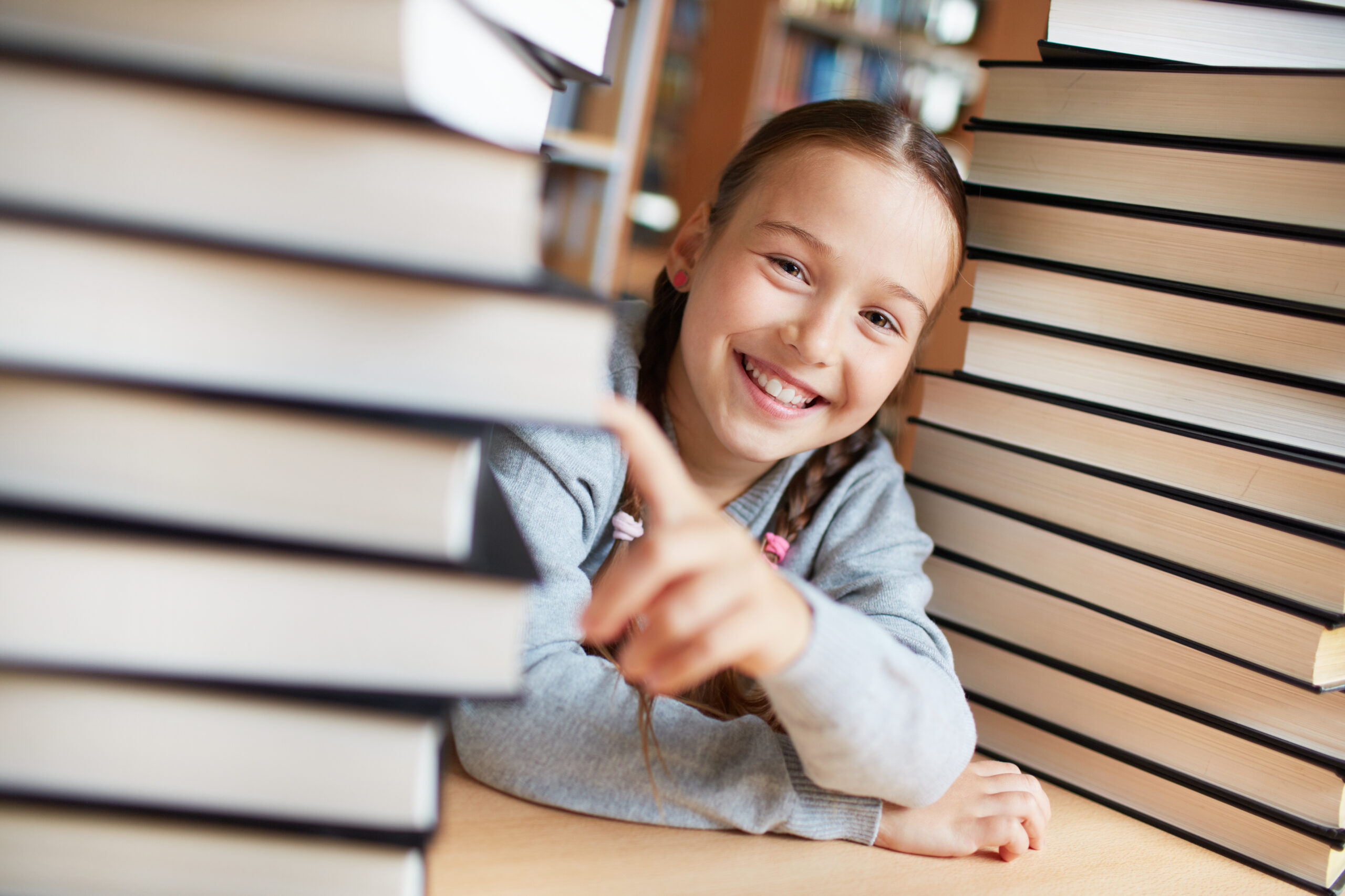 playful girl with books library scaled